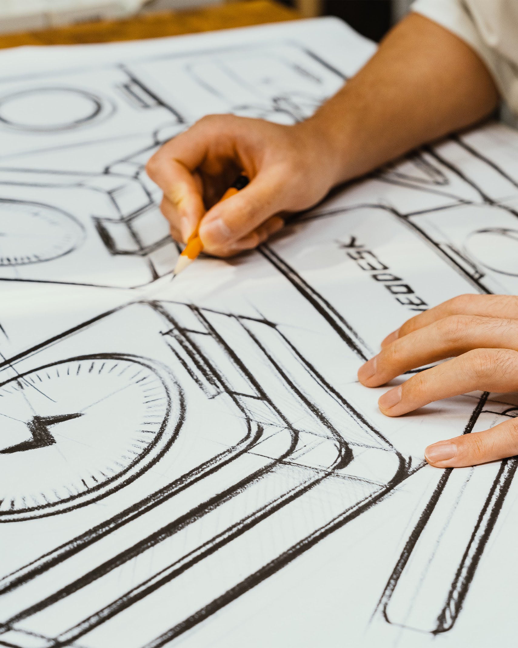Sketching NeoDesk product designs on a workspace, illustrating innovation and thoughtful craftsmanship.