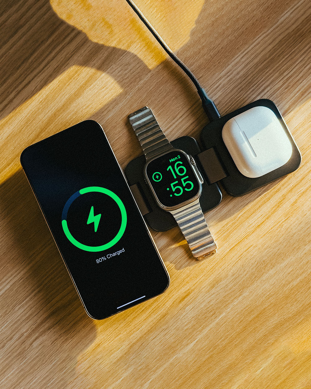 Portable 3-in-1 wireless charger showcasing flat-lay charging setup for iPhone, Apple Watch, and AirPods.