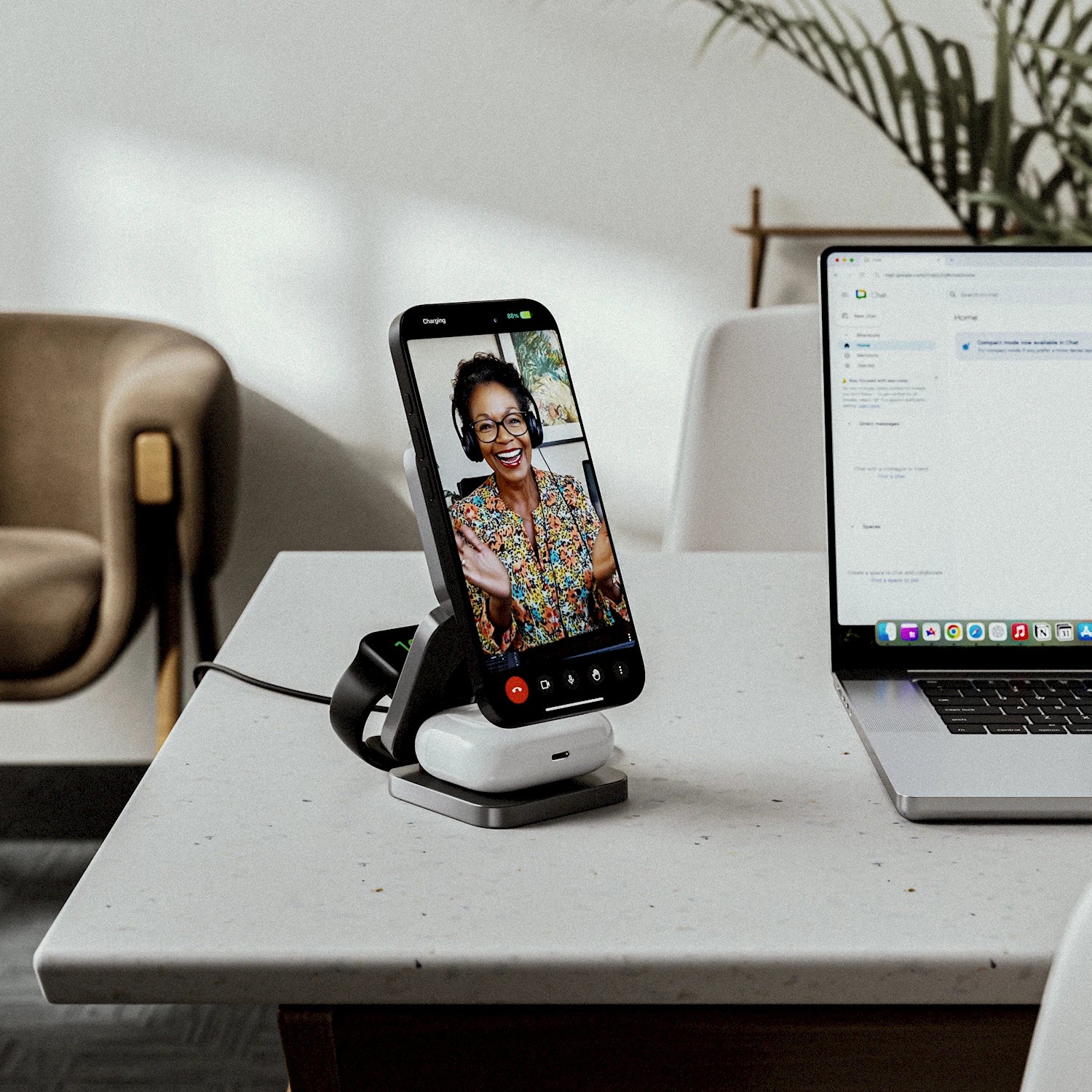 NeoDesk Portable 3-in-1 Wireless Charger used in an office setting as a stand for video calls or online meetings.