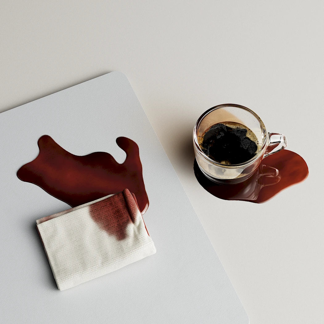 NeoDesk spill-proof and stain-resistant desk mat with coffee spill, highlighting its easy-to-clean and durable surface.