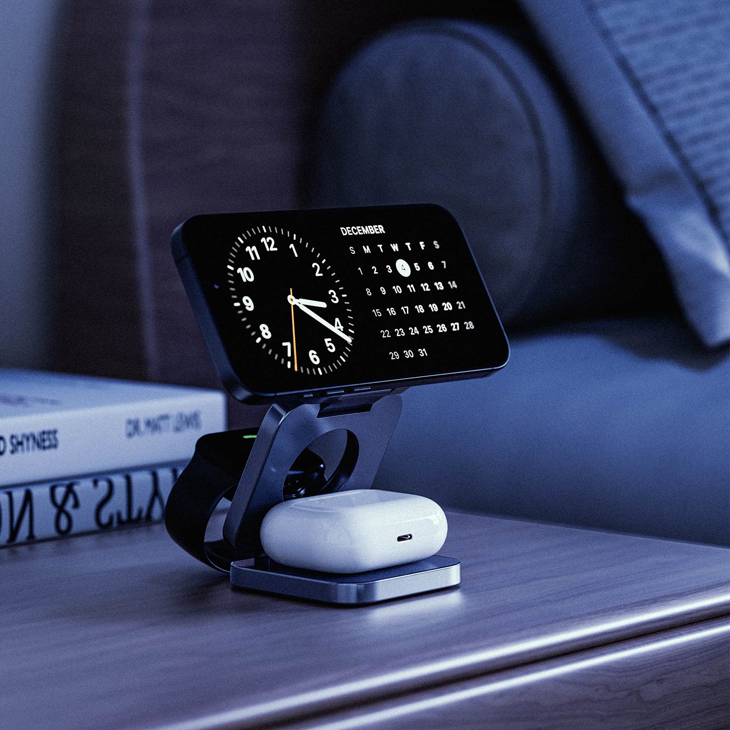 NeoDesk Portable 3-in-1 Wireless Charger on a bedside table, showcasing StandBy mode with iPhone, Apple Watch, and AirPods charging overnight.